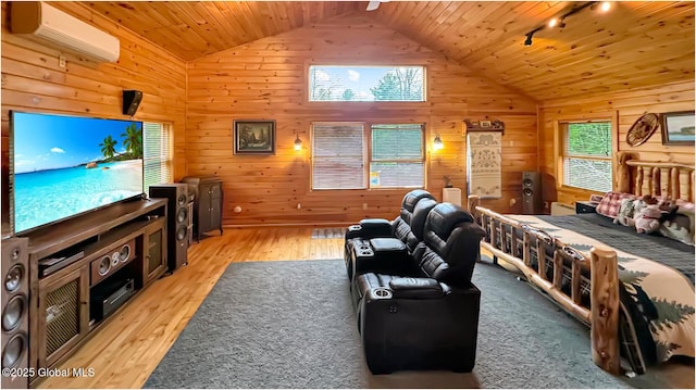 152 Sweenie Fields Rd, Schroon Lake, NY 12870 - bedroom with a wall unit AC, wooden walls, vaulted ceiling, light wood-style flooring, and rail lighting