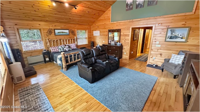 152 Sweenie Fields Rd, Schroon Lake, NY 12870 - bedroom with multiple windows, wood walls, hardwood / wood-style floors, track lighting, and wood ceiling
