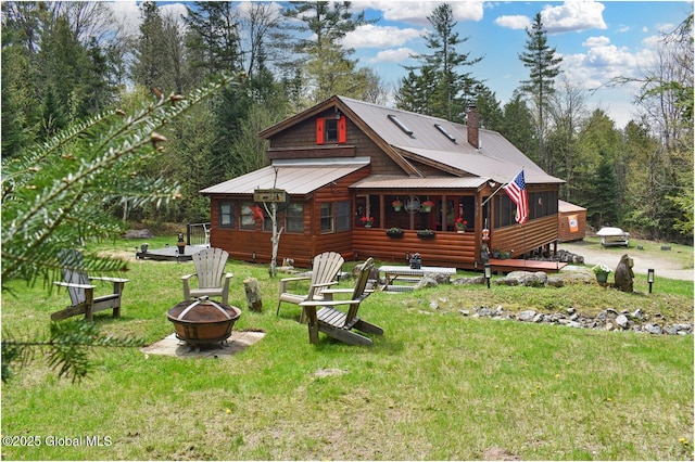 152 Sweenie Fields Rd, Schroon Lake, NY 12870 - back of property with a fire pit, a lawn, and metal roof