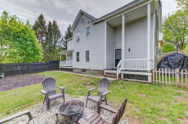 6 William St, Gloversville, NY 12078 - rear view of house with an outdoor fire pit and a wooden deck