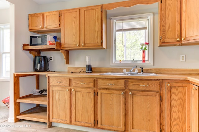 6 William St, Gloversville, NY 12078 - kitchen featuring a sink, light countertops, and open shelves