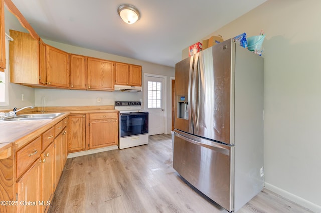 6 William St, Gloversville, NY 12078 - kitchen with electric stove, stainless steel fridge, under cabinet range hood, light countertops, and a sink