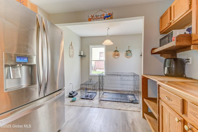 6 William St, Gloversville, NY 12078 - kitchen featuring stainless steel fridge with ice dispenser, open shelves, light wood finished floors, and butcher block countertops