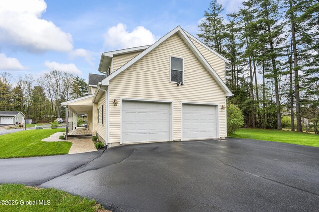 19 Karen St, Warrensburg, NY 12885 - view of home's exterior featuring driveway, a lawn, a garage, and covered porch