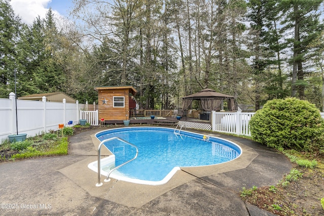 19 Karen St, Warrensburg, NY 12885 - view of swimming pool featuring a gazebo, a deck, fence, an outbuilding, and view of scattered trees