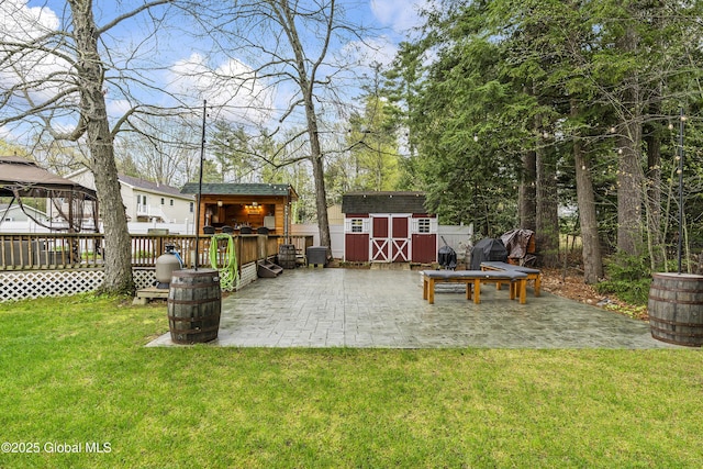 19 Karen St, Warrensburg, NY 12885 - view of green lawn featuring a gazebo, a storage shed, an outbuilding, a patio, and a deck