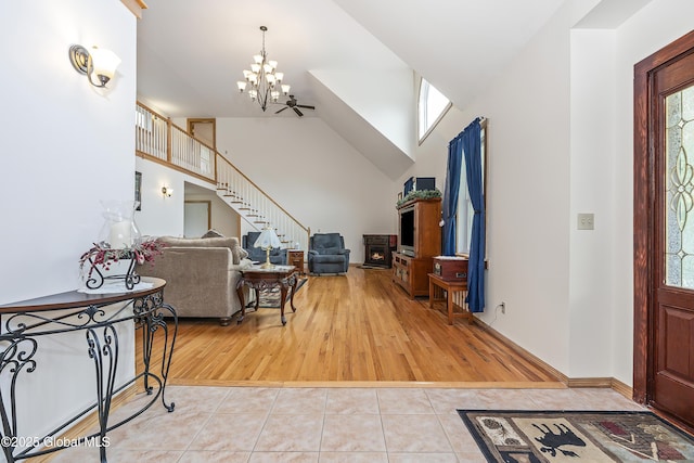 19 Karen St, Warrensburg, NY 12885 - tiled entrance foyer featuring a chandelier, stairs, and high vaulted ceiling