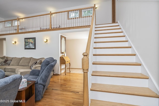 19 Karen St, Warrensburg, NY 12885 - living area with stairway, wood finished floors, and a towering ceiling