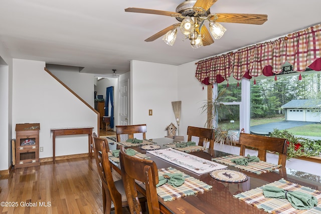 19 Karen St, Warrensburg, NY 12885 - dining area with ceiling fan, hardwood / wood-style floors, stairway, and baseboards