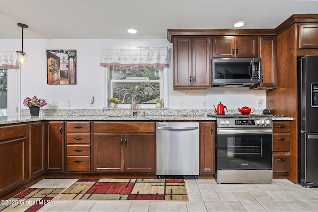 19 Karen St, Warrensburg, NY 12885 - kitchen with stainless steel appliances, a sink, light stone counters, decorative light fixtures, and light tile patterned floors