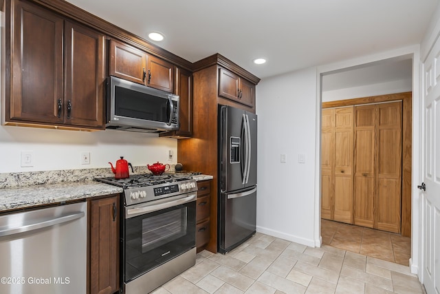 19 Karen St, Warrensburg, NY 12885 - kitchen featuring stainless steel appliances, light stone countertops, recessed lighting, baseboards, and light tile patterned flooring