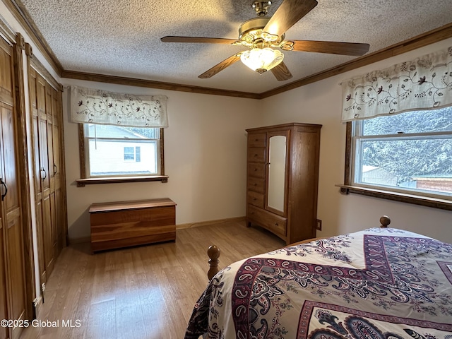 19 Karen St, Warrensburg, NY 12885 - bedroom featuring multiple windows, crown molding, light wood-style flooring, a textured ceiling, and a ceiling fan