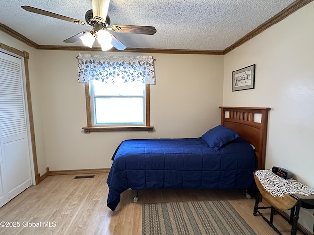 19 Karen St, Warrensburg, NY 12885 - bedroom with light wood-style floors, a textured ceiling, a ceiling fan, crown molding, and baseboards