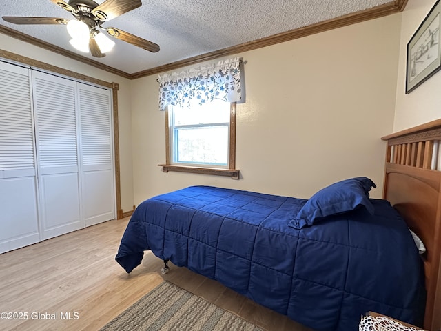 19 Karen St, Warrensburg, NY 12885 - bedroom featuring light wood finished floors, a textured ceiling, crown molding, ceiling fan, and a closet