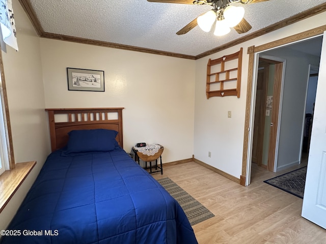 19 Karen St, Warrensburg, NY 12885 - bedroom with light wood finished floors, ornamental molding, a textured ceiling, ceiling fan, and baseboards