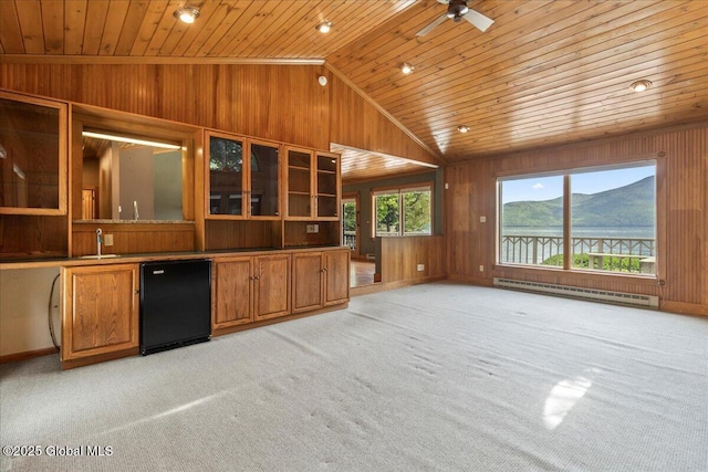 31 Fish Point Rd, Bolton, NY 12824 - kitchen featuring a baseboard heating unit, wooden ceiling, lofted ceiling, wood walls, and light colored carpet