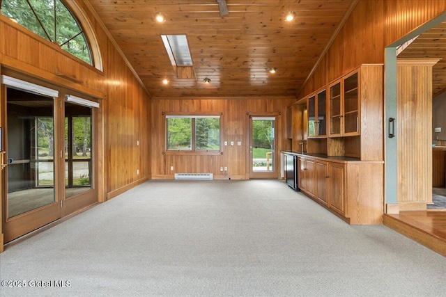 31 Fish Point Rd, Bolton, NY 12824 - unfurnished living room with baseboard heating, light colored carpet, wood ceiling, wooden walls, and lofted ceiling