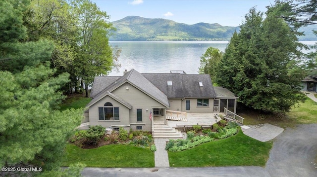 31 Fish Point Rd, Bolton, NY 12824 - view of front of property featuring a deck with water view, a front lawn, a sunroom, and stairs