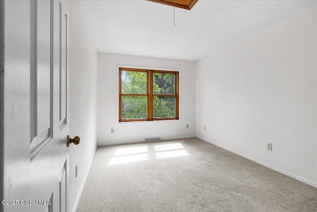 10 Tiffany Dr, Queensbury, NY 12804 - carpeted empty room featuring a textured ceiling, attic access, and baseboards