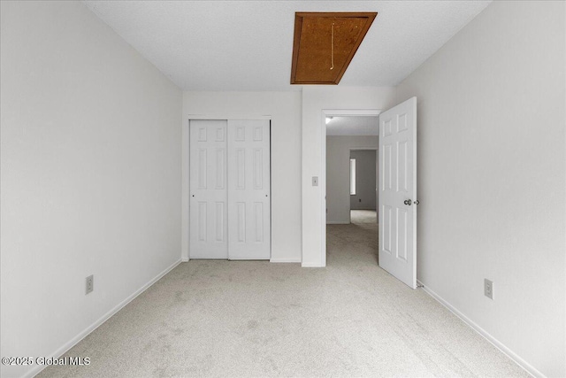 10 Tiffany Dr, Queensbury, NY 12804 - unfurnished bedroom with attic access, carpet, baseboards, and a closet