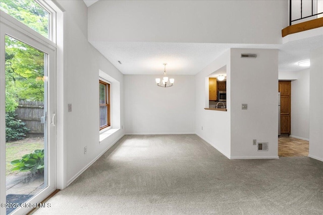 10 Tiffany Dr, Queensbury, NY 12804 - carpeted spare room with a chandelier, healthy amount of natural light, and baseboards