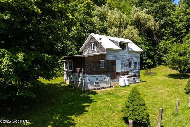 4474 State Highway 5, Fonda, NY 12068 - back of property with stone siding, a yard, and a forest view