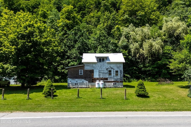 4474 State Highway 5, Fonda, NY 12068 - view of front of house with a forest view, a front lawn, and stone siding