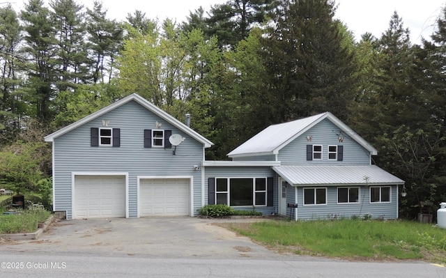 30 Prospect St, Warrensburg, NY 12885 - traditional-style home featuring driveway, an attached garage, and metal roof