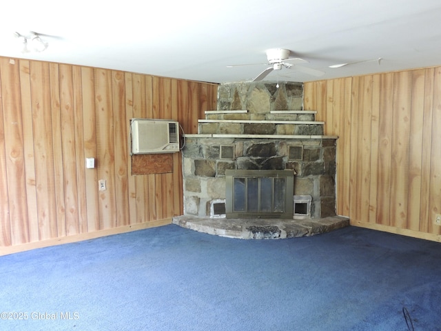 30 Prospect St, Warrensburg, NY 12885 - unfurnished living room featuring wood walls, an AC wall unit, carpet floors, a ceiling fan, and a fireplace