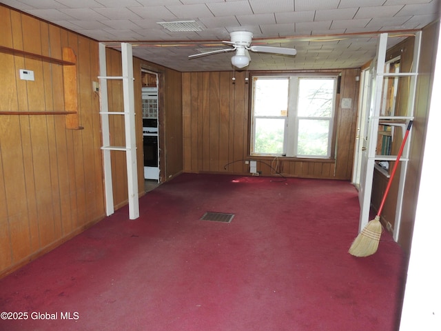 30 Prospect St, Warrensburg, NY 12885 - carpeted spare room with wood walls and a ceiling fan