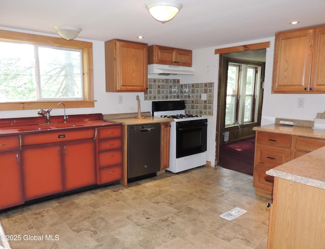 30 Prospect St, Warrensburg, NY 12885 - kitchen with black dishwasher, gas range, under cabinet range hood, a sink, and light countertops