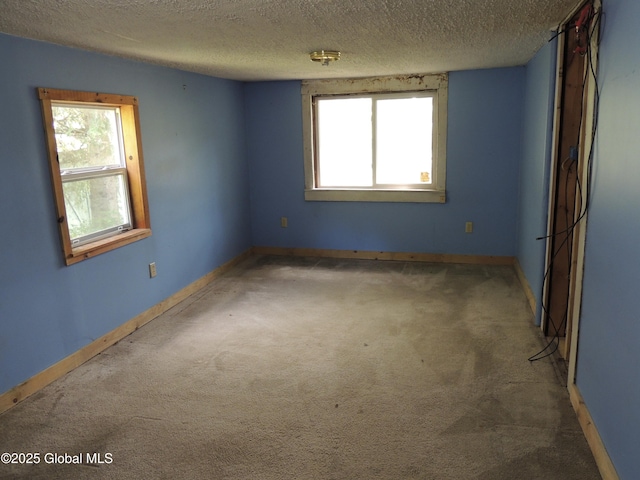 30 Prospect St, Warrensburg, NY 12885 - carpeted spare room featuring a textured ceiling and baseboards