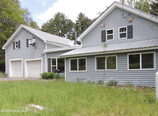 30 Prospect St, Warrensburg, NY 12885 - view of front of property featuring a garage and metal roof