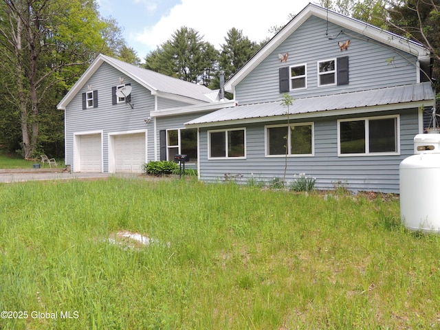 30 Prospect St, Warrensburg, NY 12885 - view of front of home featuring a garage and metal roof