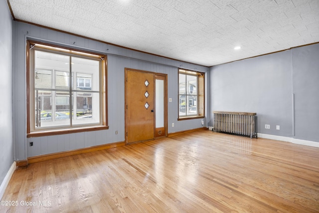 9 Archibald St, Colonie, NY 12189 - foyer featuring radiator heating unit, wood finished floors, baseboards, and crown molding