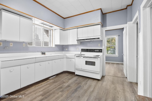 9 Archibald St, Colonie, NY 12189 - kitchen with white electric stove, under cabinet range hood, ornamental molding, white cabinetry, and tasteful backsplash