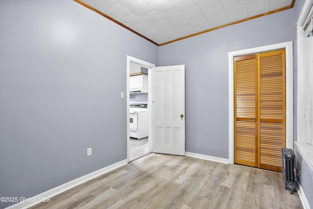 9 Archibald St, Colonie, NY 12189 - unfurnished bedroom with ornamental molding, radiator, wood finished floors, a closet, and baseboards