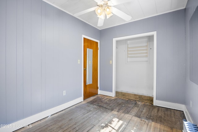 9 Archibald St, Colonie, NY 12189 - empty room featuring hardwood / wood-style floors, ceiling fan, baseboards, wooden walls, and crown molding