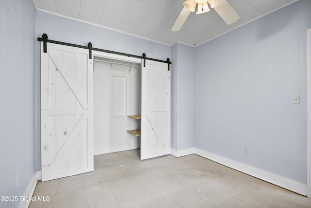 9 Archibald St, Colonie, NY 12189 - unfurnished bedroom featuring a barn door, ornamental molding, ceiling fan, baseboards, and tile patterned floors