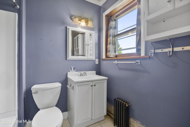 9 Archibald St, Colonie, NY 12189 - bathroom featuring radiator heating unit, toilet, vanity, and tile patterned flooring