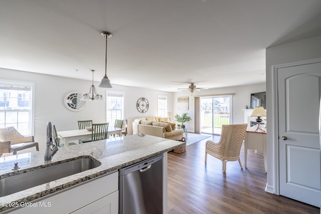 kitchen with dishwasher, a sink, healthy amount of natural light, and white cabinetry