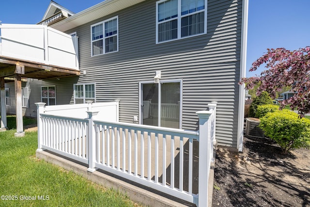 back of house featuring a deck and central AC