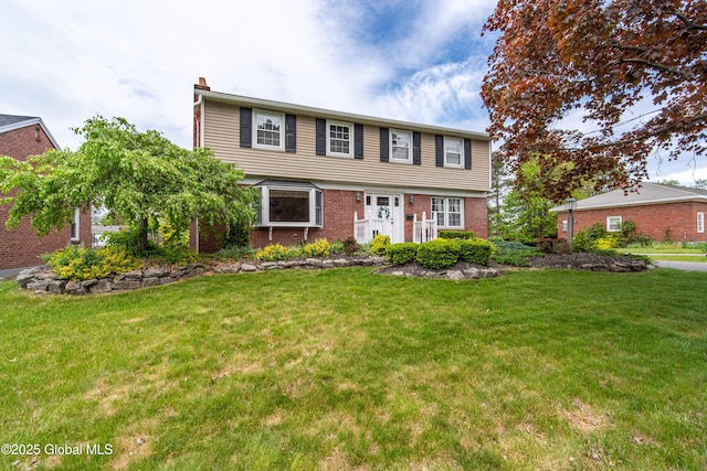 76 Mcnutt Ave, Colonie, NY 12205 - colonial-style house with a chimney, brick siding, and a front lawn