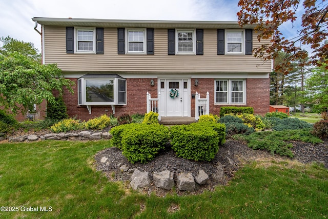 76 Mcnutt Ave, Colonie, NY 12205 - colonial home featuring a front yard and brick siding
