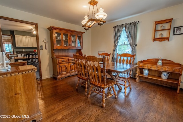76 Mcnutt Ave, Colonie, NY 12205 - dining space featuring dark wood-style floors, a chandelier, and baseboards