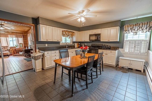 76 Mcnutt Ave, Colonie, NY 12205 - kitchen with black appliances, a ceiling fan, healthy amount of natural light, and wainscoting