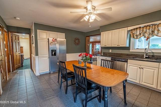 76 Mcnutt Ave, Colonie, NY 12205 - kitchen with stainless steel appliances, a sink, wainscoting, a ceiling fan, and plenty of natural light