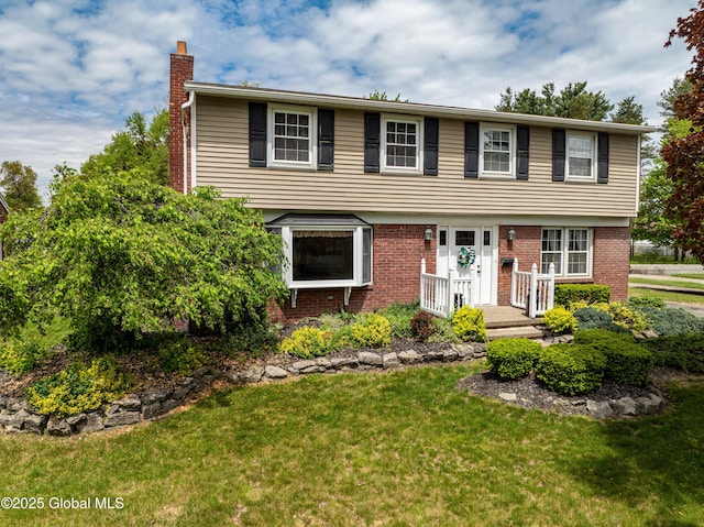 76 Mcnutt Ave, Colonie, NY 12205 - colonial inspired home featuring a chimney, a front lawn, and brick siding