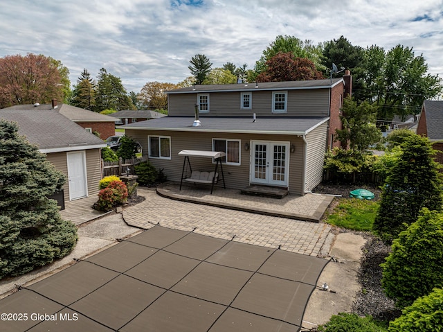 76 Mcnutt Ave, Colonie, NY 12205 - rear view of property featuring french doors, a patio, and a chimney