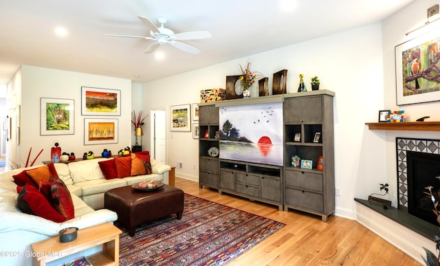 49 N Village Cir, Round Lake, NY 12151 - living room with light wood finished floors, a ceiling fan, a fireplace, recessed lighting, and baseboards